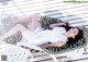 A woman laying on a white chair on a wooden deck.